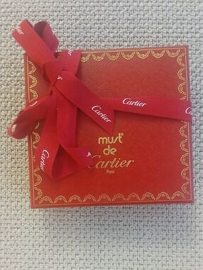 Cartier red box with gold trim and ribbon